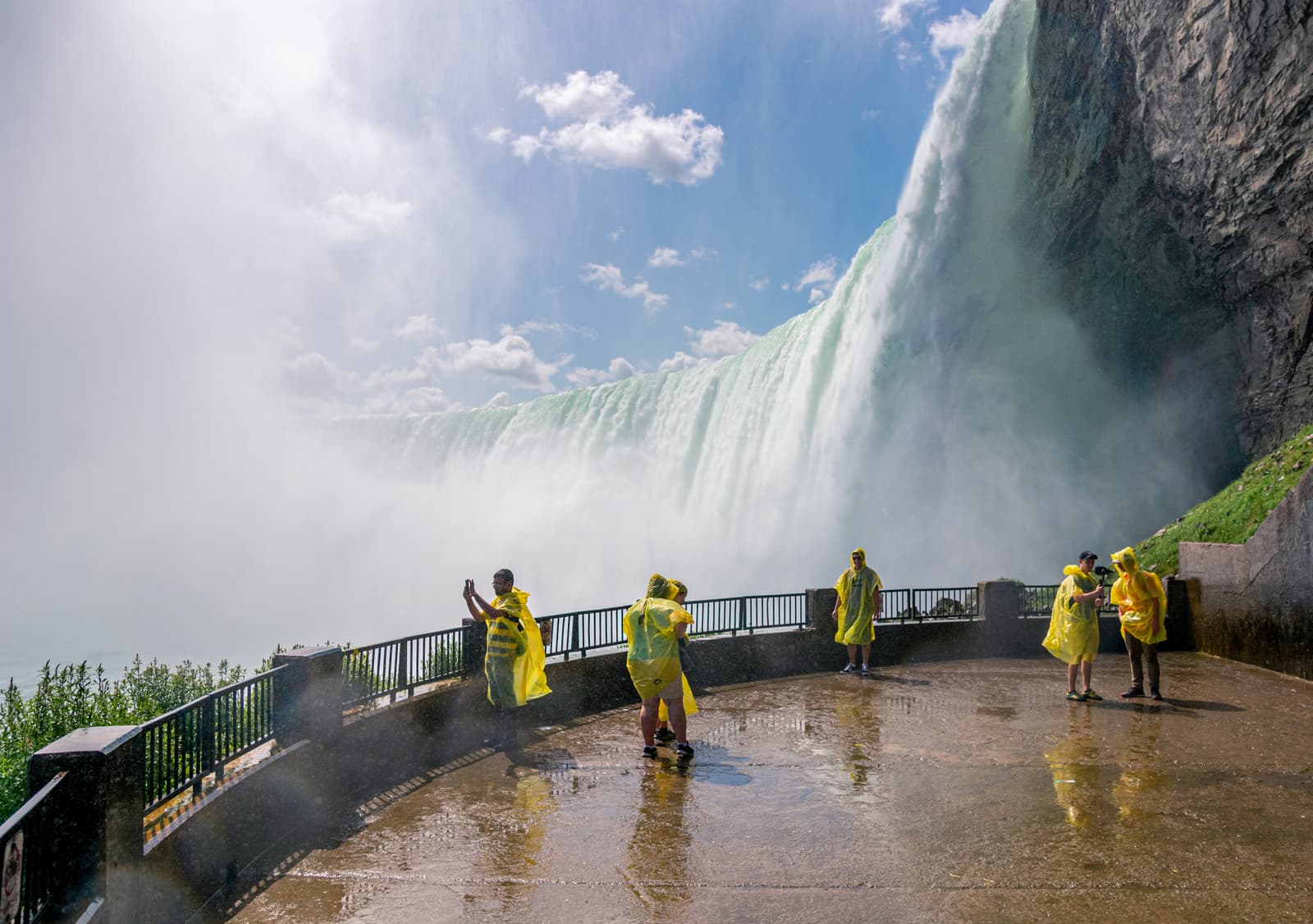 Visitors in ponchos at the Journey Behind the Falls observation deck