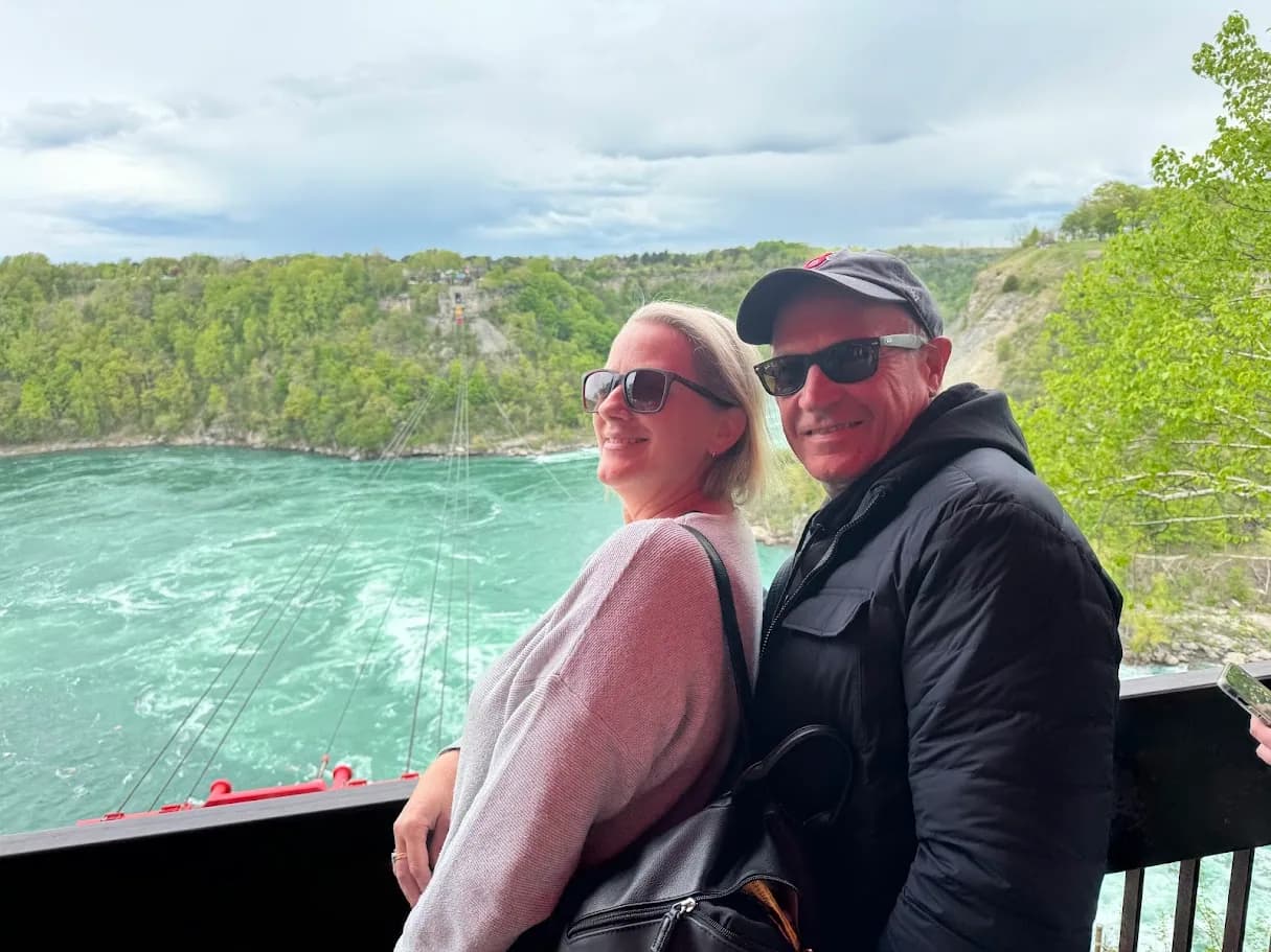 Couple posing above the turquoise Niagara Whirlpool