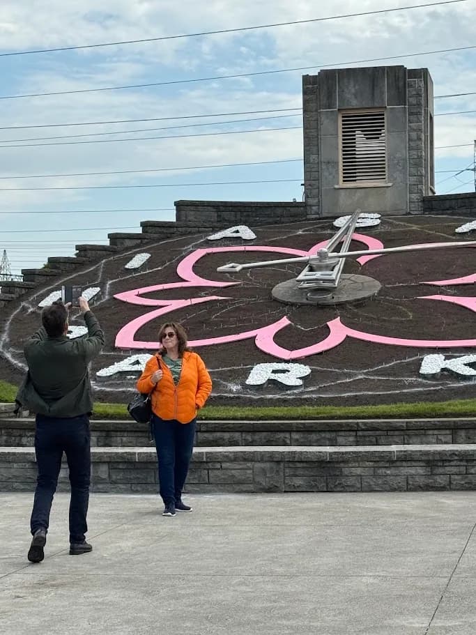 Guest posing in front of the Niagara Floral Clock