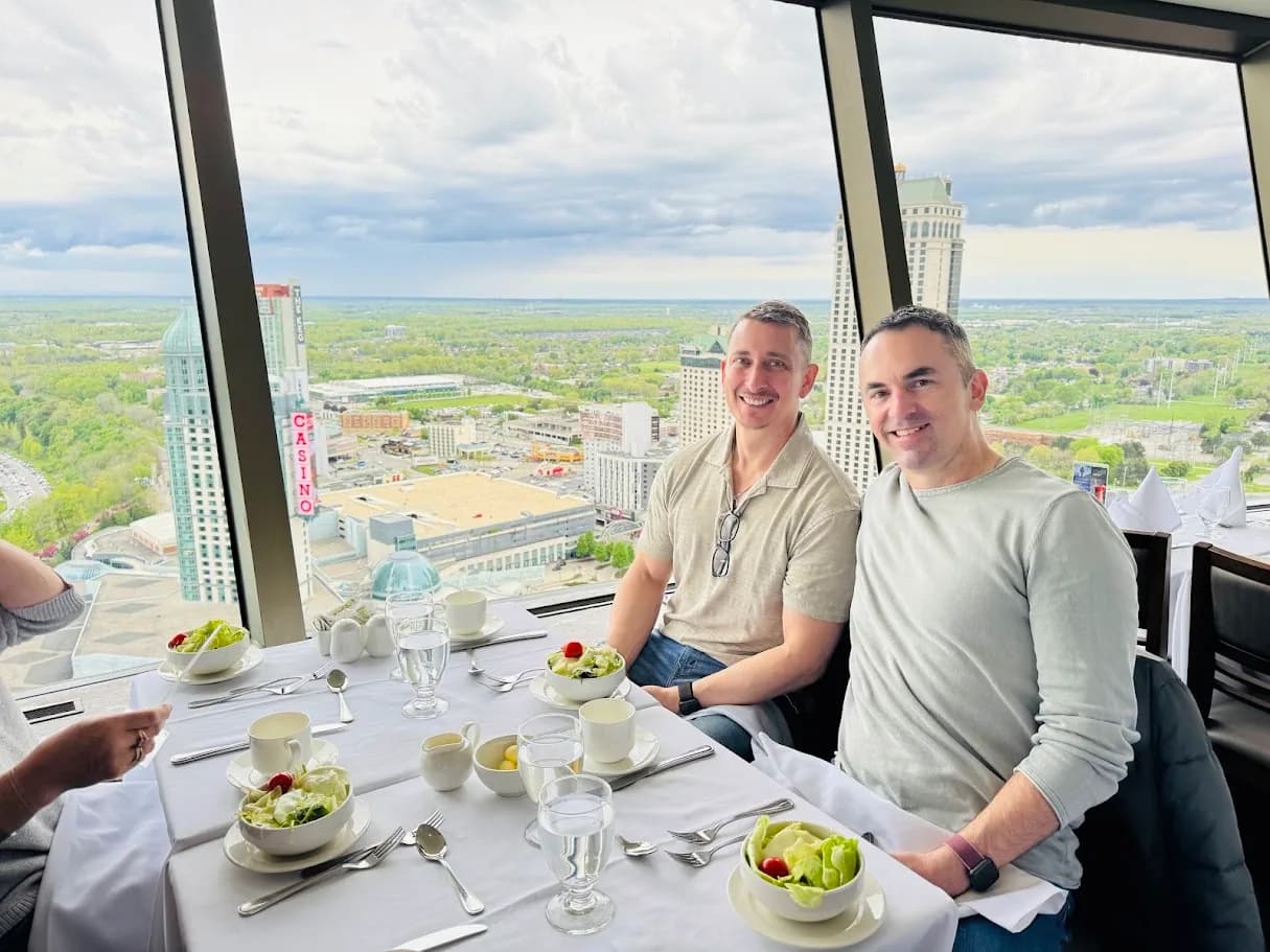 Two guests dining in a restaurant overlooking Niagara Falls
