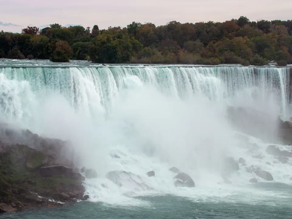 Wide view of Niagara Falls and the surrounding autumn landscape